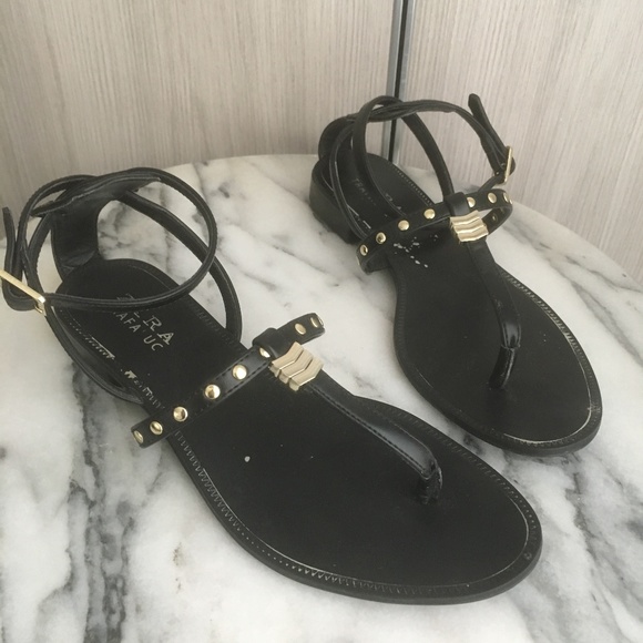 black sandals with gold trim